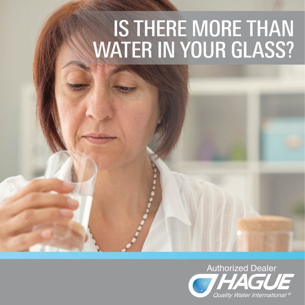 a person holding a glass of water-- water testing services in Northern Virginia
