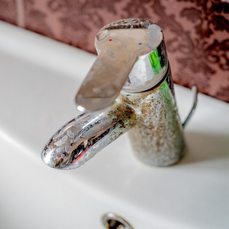 A close up of mineral scaling on a faucet